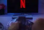 black flat screen tv turned on displaying x